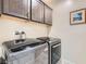 Laundry room with modern appliances and stylish cabinets offering ample storage at 2664 Ornate Regiment St, Henderson, NV 89044