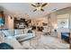 Open-concept living room flows into the kitchen, showcasing wood-look floors and neutral tones at 2664 Ornate Regiment St, Henderson, NV 89044