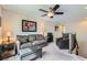 Upstairs loft living room area with comfortable seating, ceiling fan, and stairway access at 2664 Ornate Regiment St, Henderson, NV 89044