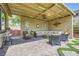 Inviting outdoor patio area, including a covered lounge, stylish landscaping, and comfortable seating at 2664 Ornate Regiment St, Henderson, NV 89044