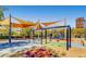 Colorful community playground featuring swings, shade structures, and various play equipment at 2664 Ornate Regiment St, Henderson, NV 89044