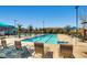 Community swimming pool with lap lanes, lounge chairs, shade umbrellas, and well-kept surroundings at 2664 Ornate Regiment St, Henderson, NV 89044