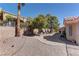 Spacious backyard featuring desert landscaping, mature trees, and privacy wall at 2739 Darby Falls Dr, Las Vegas, NV 89134