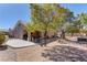 Large backyard featuring a covered patio and ample desert landscaping at 2739 Darby Falls Dr, Las Vegas, NV 89134