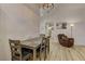 Dining room area with hardwood floors next to a living room with cozy chair at 2739 Darby Falls Dr, Las Vegas, NV 89134