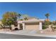 Single-story home featuring well-maintained desert landscaping and a spacious two-car garage at 2739 Darby Falls Dr, Las Vegas, NV 89134