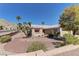 Desert landscaping of this one story home includes a large tree and multiple palm trees at 2739 Darby Falls Dr, Las Vegas, NV 89134