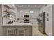 Spacious kitchen boasts white cabinets, stainless steel appliances, and a large island with seating at 2739 Darby Falls Dr, Las Vegas, NV 89134