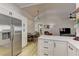 Open-concept kitchen features stainless steel appliances, white cabinets, and seamless flow to dining and living areas at 2739 Darby Falls Dr, Las Vegas, NV 89134