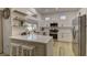 Modern kitchen with white cabinets, a breakfast bar, and stainless steel appliances at 2739 Darby Falls Dr, Las Vegas, NV 89134