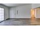 Sunlit living space featuring wood-look floors and a door to a bathroom with easy access at 3318 N Decatur Blvd # 2138, Las Vegas, NV 89130