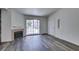 Bright living room with a fireplace, sliding glass doors, and modern gray wood flooring at 3318 N Decatur Blvd # 2138, Las Vegas, NV 89130