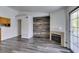 Spacious living room featuring a fireplace, modern wood-look flooring, and a sliding glass door to a balcony at 3318 N Decatur Blvd # 2138, Las Vegas, NV 89130