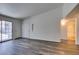 Open living space with wood-look floors, sliding glass doors, and convenient access to a full bathroom at 3318 N Decatur Blvd # 2138, Las Vegas, NV 89130