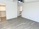 Bedroom features neutral walls, light wood-look flooring, ceiling fan, and access to both closet and hallway at 3484 Nightflower Ln # 2, Las Vegas, NV 89121