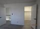 Bedroom with access to walk-in closet and hallway with wood-look flooring and neutral walls at 3484 Nightflower Ln # 2, Las Vegas, NV 89121