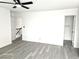 Spacious bedroom features a ceiling fan, neutral walls, light wood-look floors, and access to both bathroom and hallway at 3484 Nightflower Ln # 2, Las Vegas, NV 89121