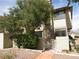 Two-story home with white siding, brick accents, mature trees, and well-maintained landscaping at 3484 Nightflower Ln # 2, Las Vegas, NV 89121