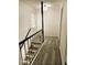Bright hallway features wood-look flooring, staircase with black railings, and a window providing natural light at 3484 Nightflower Ln # 2, Las Vegas, NV 89121