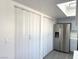 View of the kitchen with stainless steel refrigerator and white closet doors at 3484 Nightflower Ln # 2, Las Vegas, NV 89121