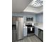 Modern kitchen features stainless steel appliances and light blue cabinets and countertops at 3484 Nightflower Ln # 2, Las Vegas, NV 89121