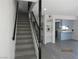 View of staircase with gray treads and black banister and kitchen view at 3484 Nightflower Ln # 2, Las Vegas, NV 89121