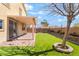Backyard features a covered patio, artificial grass, and brick landscaping, creating an inviting outdoor space at 3517 Colby Creek Ave, North Las Vegas, NV 89081