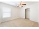 Bright bedroom featuring a ceiling fan, window and closet space, perfect for relaxation at 3517 Colby Creek Ave, North Las Vegas, NV 89081