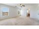 Large bright bedroom with carpet, a ceiling fan, and windows with outside views at 3517 Colby Creek Ave, North Las Vegas, NV 89081