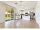 Expansive kitchen with stainless appliances, white cabinets, island, and access to backyard patio at 3517 Colby Creek Ave, North Las Vegas, NV 89081