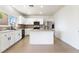 Bright, open kitchen featuring an island, stainless steel appliances, and white cabinetry at 3517 Colby Creek Ave, North Las Vegas, NV 89081