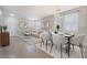 Bright living room with neutral decor, a dining table, and large windows offering ample natural light at 3517 Colby Creek Ave, North Las Vegas, NV 89081