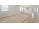 Open-concept living area featuring neutral carpet, tile flooring, and natural light from large windows at 3517 Colby Creek Ave, North Las Vegas, NV 89081
