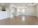 Bright living room boasts tile flooring, a ceiling fan, and an open floor plan into other rooms at 3517 Colby Creek Ave, North Las Vegas, NV 89081