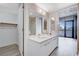 Modern bathroom with double sinks, a walk-in shower, and a view of the city at 353 E Bonneville Ave # 449, Las Vegas, NV 89101