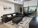Stylish living room featuring a sectional sofa and large windows, perfect for relaxing and entertaining guests at 353 E Bonneville Ave # 449, Las Vegas, NV 89101