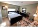 Cozy bedroom featuring a queen bed, floral chair, and dark wood furnishings at 3550 Bay Sands Dr # 3044, Laughlin, NV 89029