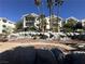 Inviting condo complex featuring balconies, meticulous landscaping with palm trees, rock features, and vibrant desert plants at 3550 Bay Sands Dr # 3044, Laughlin, NV 89029