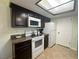 This kitchen features granite countertops, dark wood cabinets, and modern appliances at 3550 Bay Sands Dr # 3044, Laughlin, NV 89029