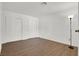 Spacious bedroom featuring wood-look floors, closet, and modern lighting at 3609 Melonies Dr # 93, Las Vegas, NV 89103