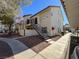 Two-story stucco condo building with wrought iron balcony and staircase, sidewalk, and desert landscaping at 3609 Melonies Dr # 93, Las Vegas, NV 89103