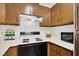 Kitchen featuring light countertops, wood cabinets, stove, oven and multiple bottles on the counter at 3609 Melonies Dr # 93, Las Vegas, NV 89103