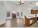 Bright living room features a brick fireplace, wood flooring, and a pass-through bar to the kitchen at 3609 Melonies Dr # 93, Las Vegas, NV 89103