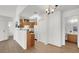 Open living space with wood floors, white walls, wood cabinets and breakfast bar looking into a small kitchen at 3609 Melonies Dr # 93, Las Vegas, NV 89103