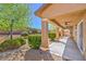 A covered back patio with a cozy outdoor space and desert landscaping at 4399 Luciano Ave, Pahrump, NV 89061