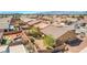 An aerial view of a cozy backyard with gravel, a brick fence, desert landscaping, and a pool at 4399 Luciano Ave, Pahrump, NV 89061