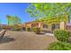 Private backyard featuring manicured landscaping, a covered patio, and a desert landscape at 4399 Luciano Ave, Pahrump, NV 89061
