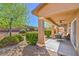 Cozy covered patio with outdoor seating and a well-maintained backyard with mature landscaping, perfect for relaxation at 4399 Luciano Ave, Pahrump, NV 89061