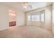 Spacious bedroom with natural light, neutral paint, carpet flooring, and an attached bathroom at 4399 Luciano Ave, Pahrump, NV 89061