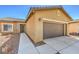 A single-story home featuring a two-car garage and low-maintenance desert landscaping at 4399 Luciano Ave, Pahrump, NV 89061